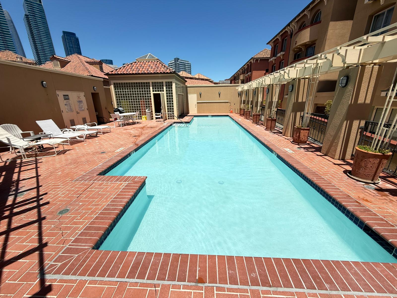 After photo of commercial swimming pool replaster in San Francisco by Tide Wave Pools, showing smooth new plaster finish and clean waterline tile.